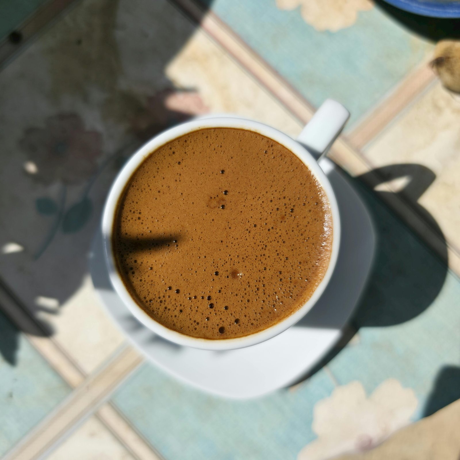 Macro shot of Turkish coffee with rich foam, captured on a sunny day in Nicosia, Cyprus.
